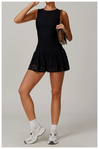 Detailed shot of black lace sleeveless dress with pleated skirt and mesh details