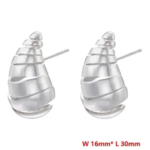 Macro shot showing dimensions of silver spiral shell earrings measuring 16mm by 30mm