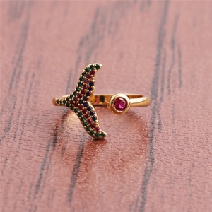 Close-up of golden fishtail open ring with vibrant micro-set red, green, and blue zircon gems