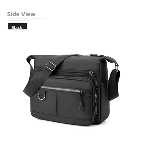 Side view of multi-pocket black waterproof shoulder bag showing layered zipper design