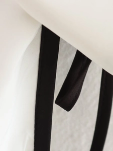 Macro view of high-quality contrast stitching on black and white casual jacket
