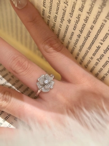 Detail of camellia flower ring with pavé zircons on silver petals for a luxury look