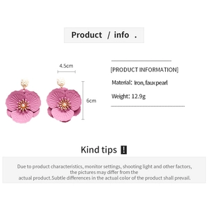Detail showing matte purple flower earrings with pearl center and 6cm x 4.5cm dimensions