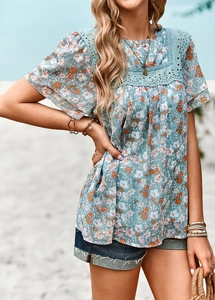Close-up of floral print top featuring intricate lace trim on sleeves and neckline