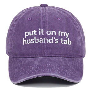 Detailed close-up of white embroidery on a vintage washed purple cotton baseball cap