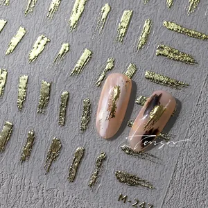 Detail of M-247 gold foil nail stickers with brush stroke texture on neutral nails