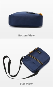 Detail view of the navy canvas messenger bag showing bottom and flat lay display