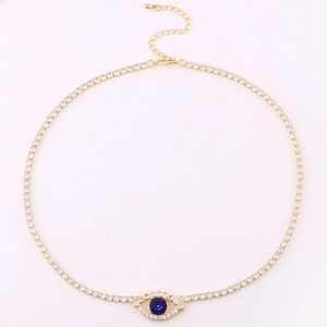 Detail of gold evil eye necklace with blue zircon and full diamond tennis chain closure