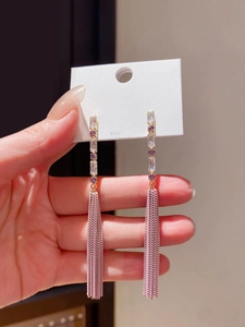 Detailed macro view of S925 silver fringe earrings with gold plating and purple tassels
