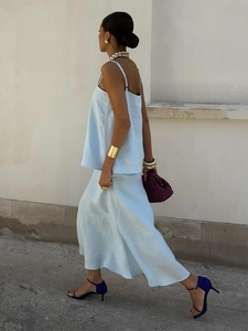 Chic light blue linen two-piece set featuring thin strap top and fishtail maxi skirt