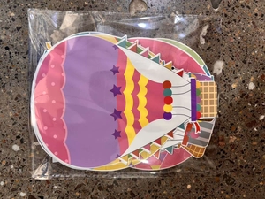 Detailed view of colorful hot air balloon paper cutouts in clear plastic packaging