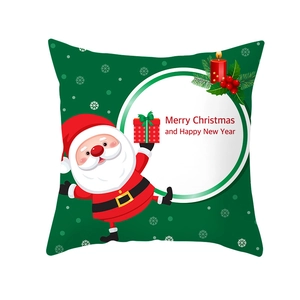Detail of green Christmas pillow cover with Santa Claus holding a gift and holiday greeting