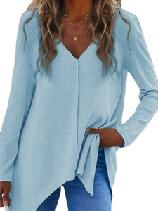 Detail of light blue V-neck knit top with side slit hem and textured fabric finish