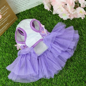 Close-up of purple layered mesh tutu pet dress with floral accent on green grass