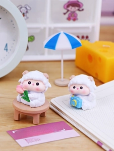 Miniature cute sheep figurines with pink tulip and camera for desktop decor