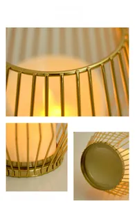 Detail view of the golden metal wireframe lantern with warm electronic candle light