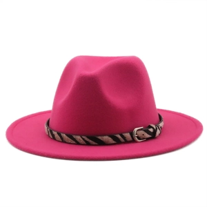 Close-up of fuchsia wool fedora hat with zebra pattern strap and silver buckle