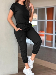 Detail view of women's black short sleeve jumpsuit with drawstring waist and cargo pockets