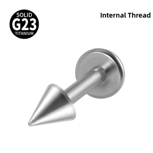 Detailed macro view of G23 solid titanium labret stud with internal thread and spike top
