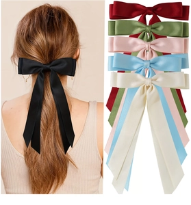 Detail of long tail satin bow hair clip in multiple colors with silky flowing ribbon