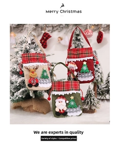 Close-up of burlap Christmas gift bags with plush Santa, Snowman and Reindeer characters