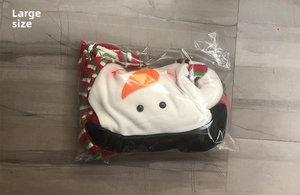 Detail of a large felt snowman Christmas tree topper in transparent packaging