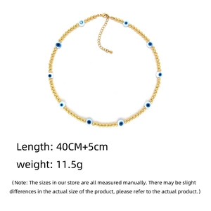 Close-up of 18K gold beaded Turkish evil eye necklace with lobster clasp detail