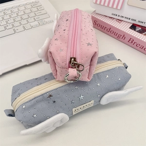 Detail view of canvas pencil cases featuring 3D angel wings and silver star patterns