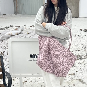 Fashionable pink leopard print tote bag with slim straps in a winter outdoor setting