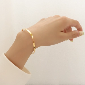 Minimalist 18k gold plated stainless steel twisted bangle bracelet for women on wrist