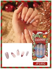 Macro detail of Christmas themed fake nails with red ribbons and candy cane stripes