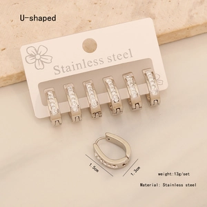 Detailed view of silver U-shaped stainless steel earrings with sparkling rhinestones
