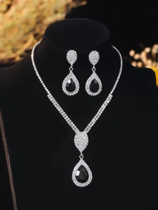 Detailed view of luxury silver bridal jewelry set with black pear-cut stones and white crystals
