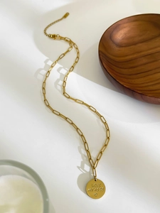 Detail of 18K gold paperclip chain necklace with round Love My Kids engraved pendant