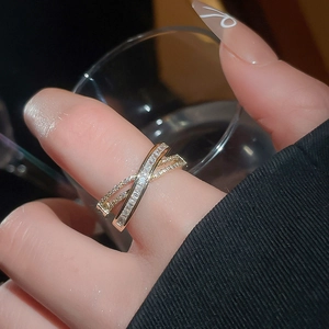 Detailed view of 18k gold plated criss-cross ring with pavé zircons and baguette stones