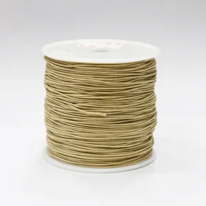 Detailed macro view of 0.8mm light brown waxed thread roll for DIY jewelry making