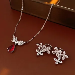 Luxurious silver necklace and earring set with red pear-cut stone and zircon flower