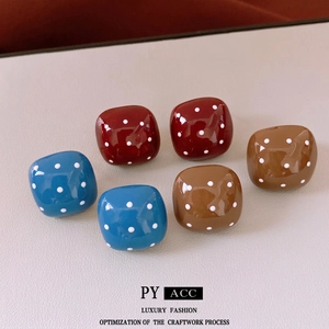 Three pairs of vintage square polka dot stud earrings in blue, red, and amber resin colors