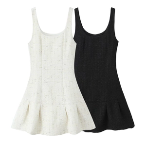 Detailed macro view of black and white tweed fabric texture on sleeveless A-line dresses