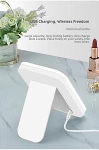 Detail of white LED makeup mirror with USB charging port and sturdy folding stand