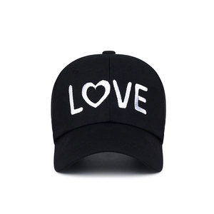 Minimalist black baseball cap featuring white LOVE embroidery and heart-shaped detail