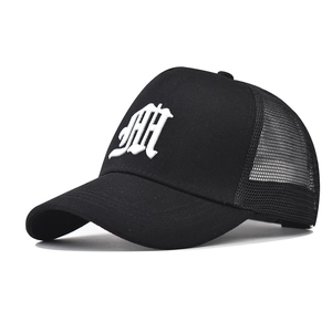 Close-up of gothic white letter A embroidery on a black mesh cotton trucker baseball cap