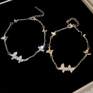 Elegant butterfly bracelet with zircon stones in gold and silver finish on black velvet