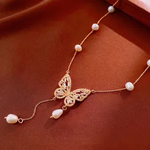 Gold plated butterfly necklace with sparkling cubic zirconia and white irregular pearls