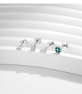 Detail of S925 sterling silver studs with clover, lock, and leaf designs with zircon stones