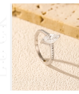 Macro view of marquise cut moissanite ring set on natural stone for a vintage look