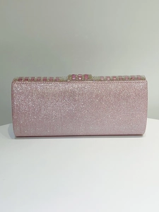 Close-up of pink glitter evening clutch bag with rectangular rhinestone top buckle