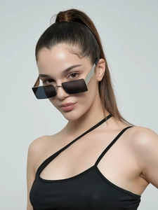 Close-up of vintage rectangular sunglasses with silver metal temples on model