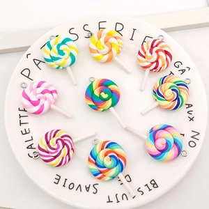 Close-up of colorful resin lollipop pendants with metal loops for DIY jewelry making