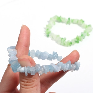 Handheld view of natural agate crystal stretch bracelet with sky blue irregular stones